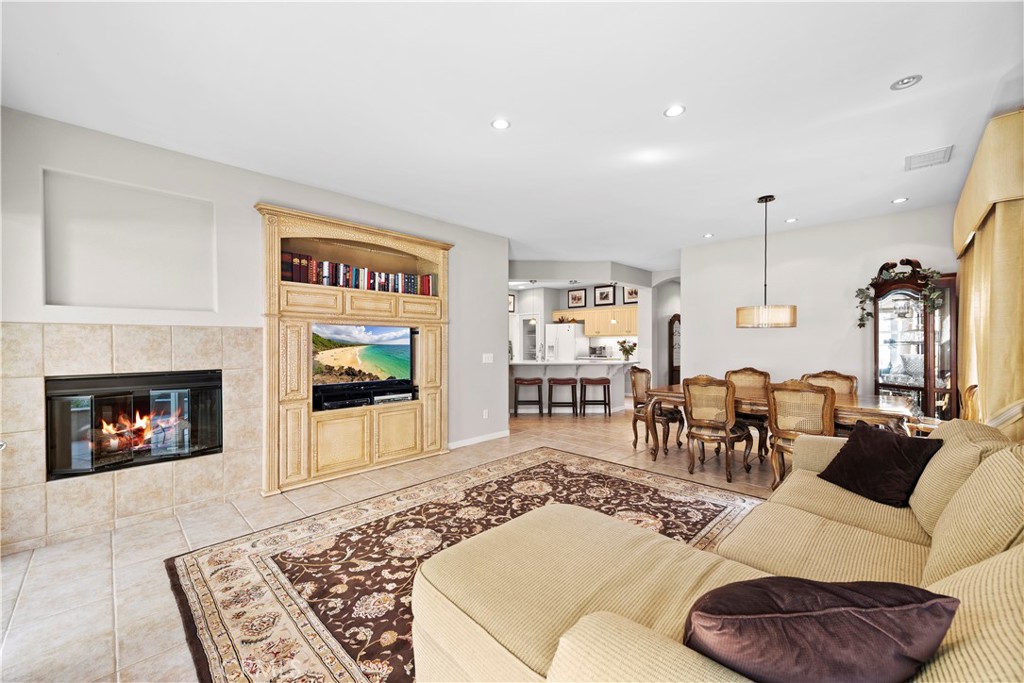 24575 Lowe Drive Corona, CA 92883 - Photo 44 of 44 a living room with furniture a fireplace and a flat screen tv