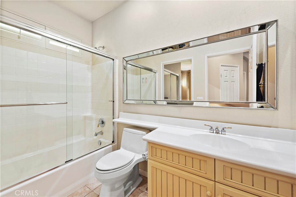 24575 Lowe Drive Corona, CA 92883 - Photo 14 of 44 a bathroom with a granite countertop sink a toilet a mirror and shower