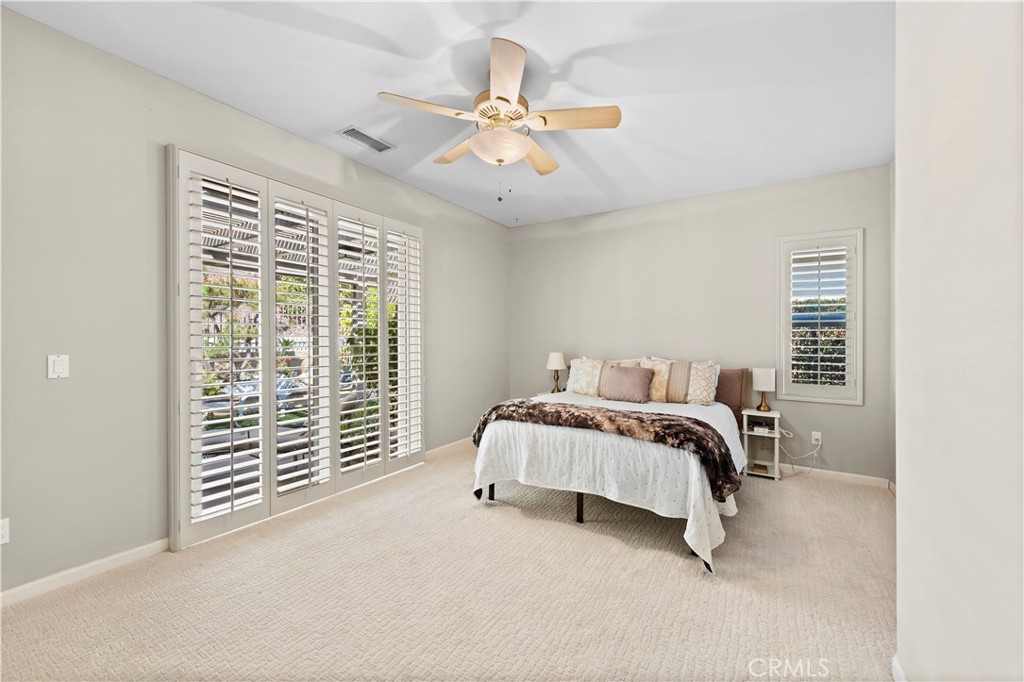 24575 Lowe Drive Corona, CA 92883 - Photo 15 of 44 a bedroom with a bed and a chandelier