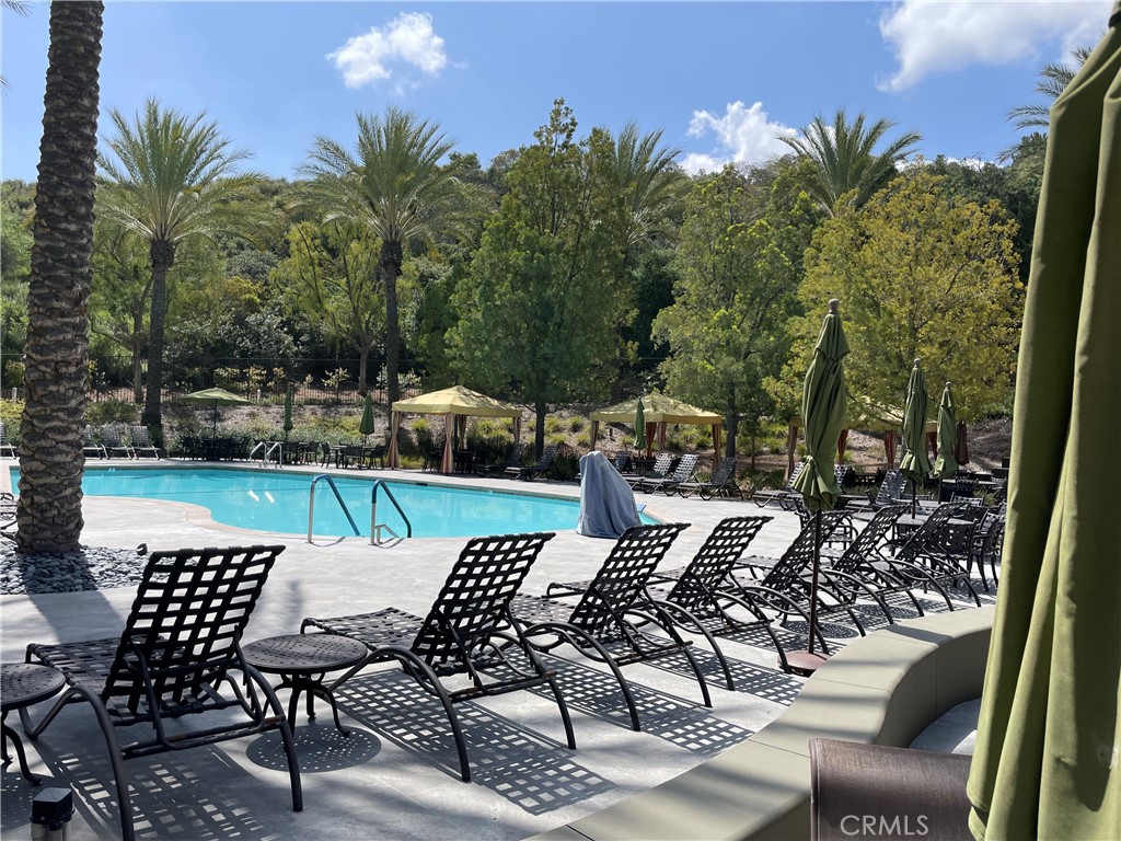 24575 Lowe Drive Corona, CA 92883 - Photo 34 of 44 a view of a patio with table and chairs and potted plants with wooden floor and fence