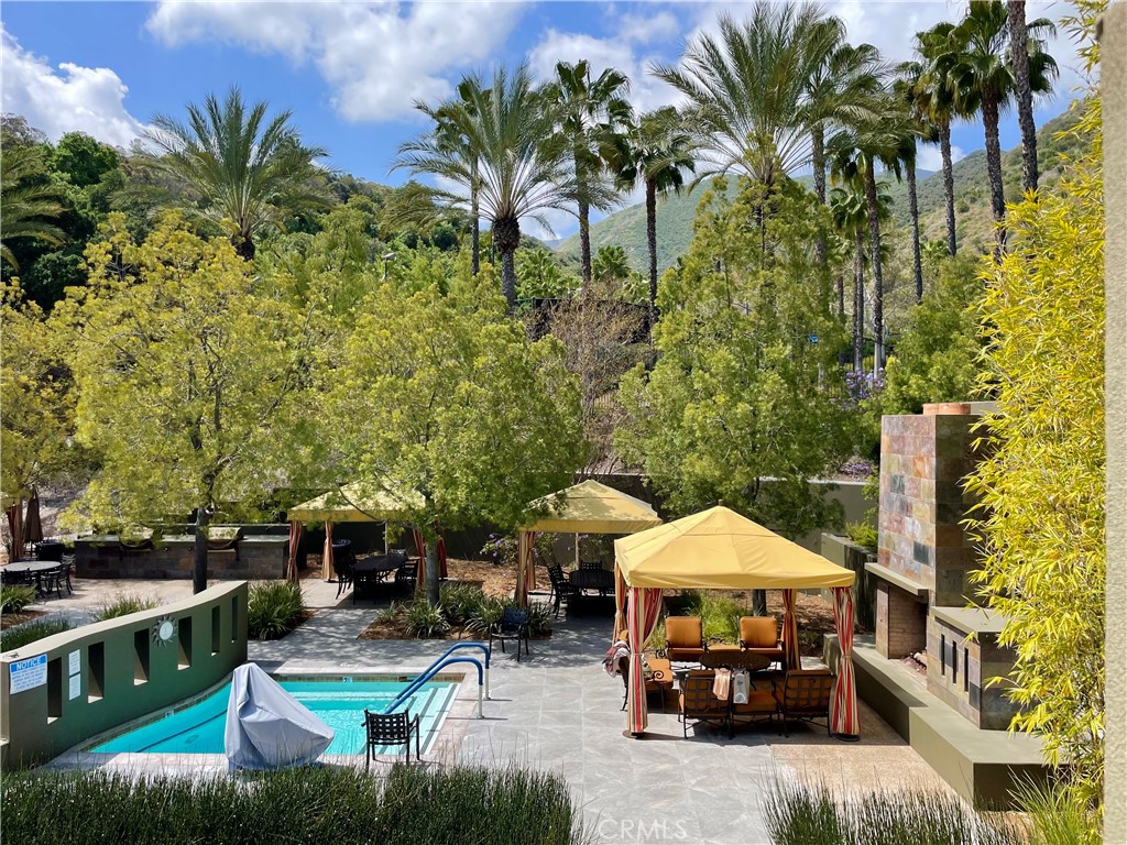 24575 Lowe Drive Corona, CA 92883 - Photo 36 of 44 a view of a patio with table and chairs under an umbrella