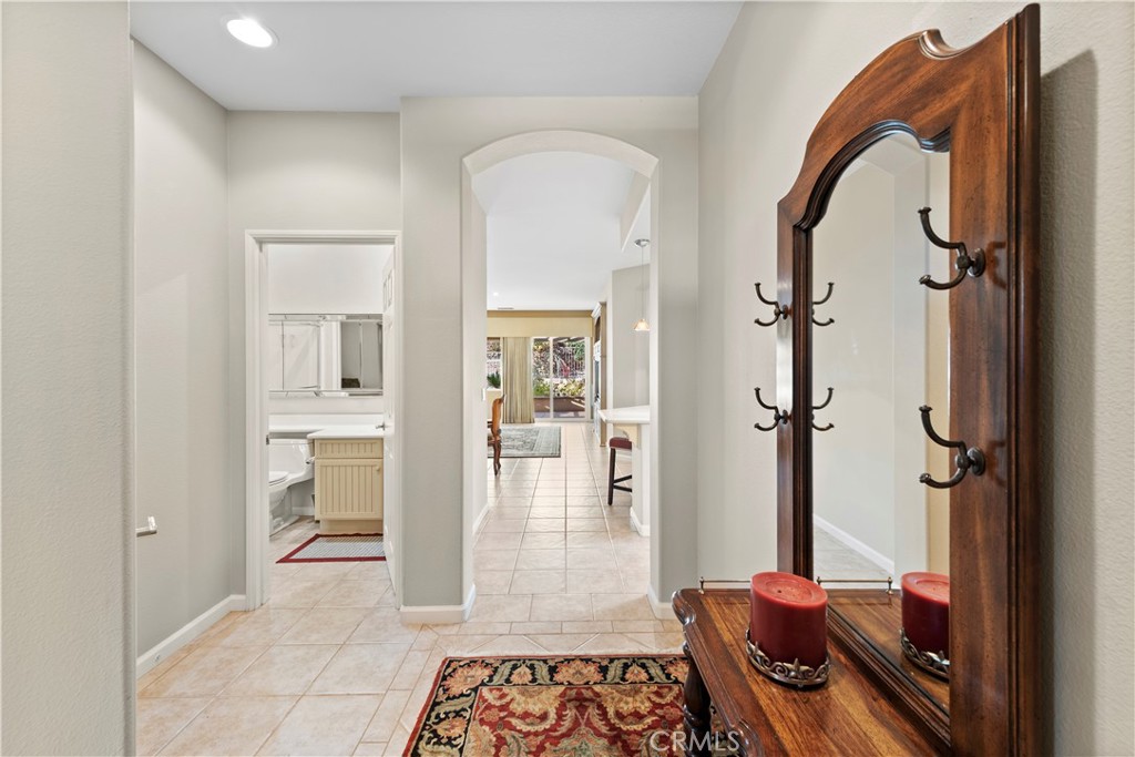 24575 Lowe Drive Corona, CA 92883 - Photo 4 of 44 a view of a hallway with wooden floor and living room