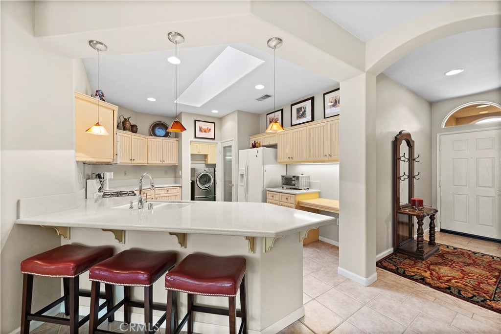 24575 Lowe Drive Corona, CA 92883 - Photo 5 of 44 a kitchen with stainless steel appliances kitchen island granite countertop a dining table and chairs