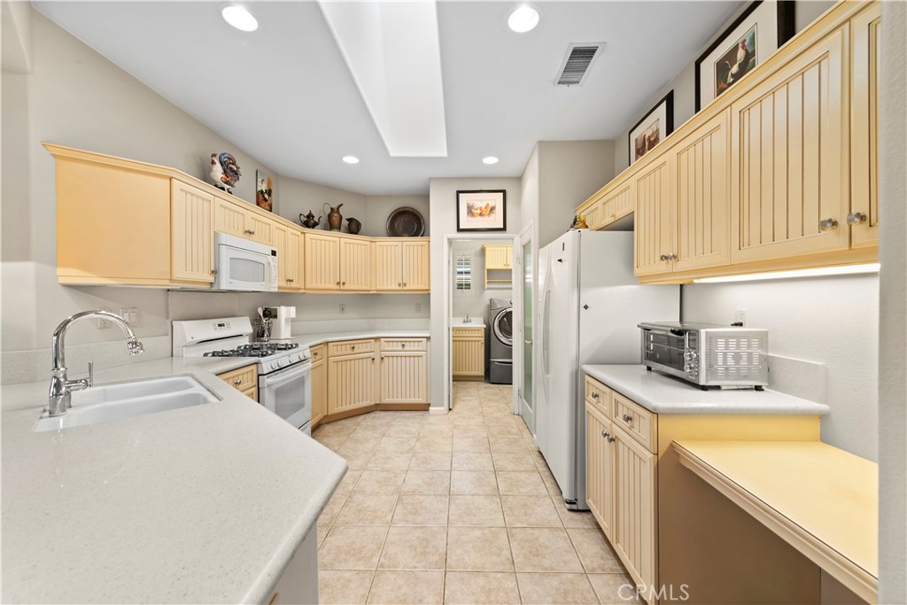 24575 Lowe Drive Corona, CA 92883 - Photo 6 of 44 a kitchen with stainless steel appliances granite countertop a sink and cabinets