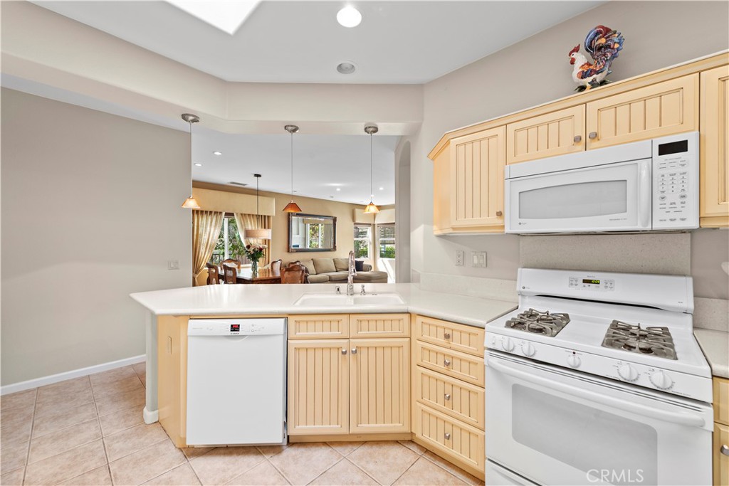 24575 Lowe Drive Corona, CA 92883 - Photo 8 of 44 a kitchen with white cabinets and white appliances