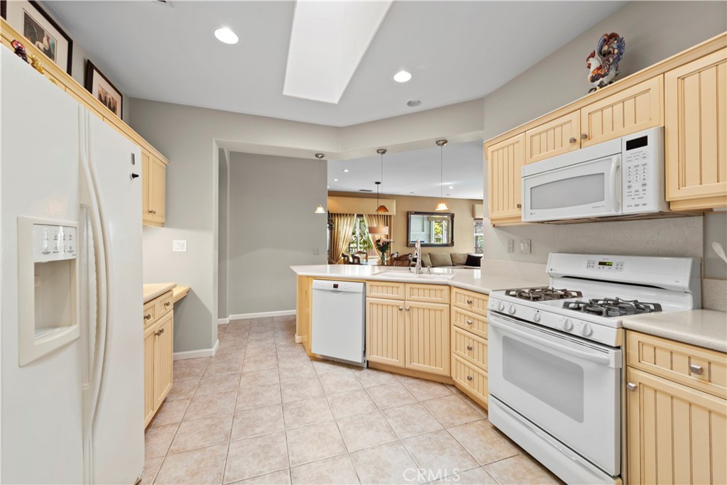 24575 Lowe Drive Corona, CA 92883 - Photo 9 of 44 a kitchen with a stove a sink and a refrigerator