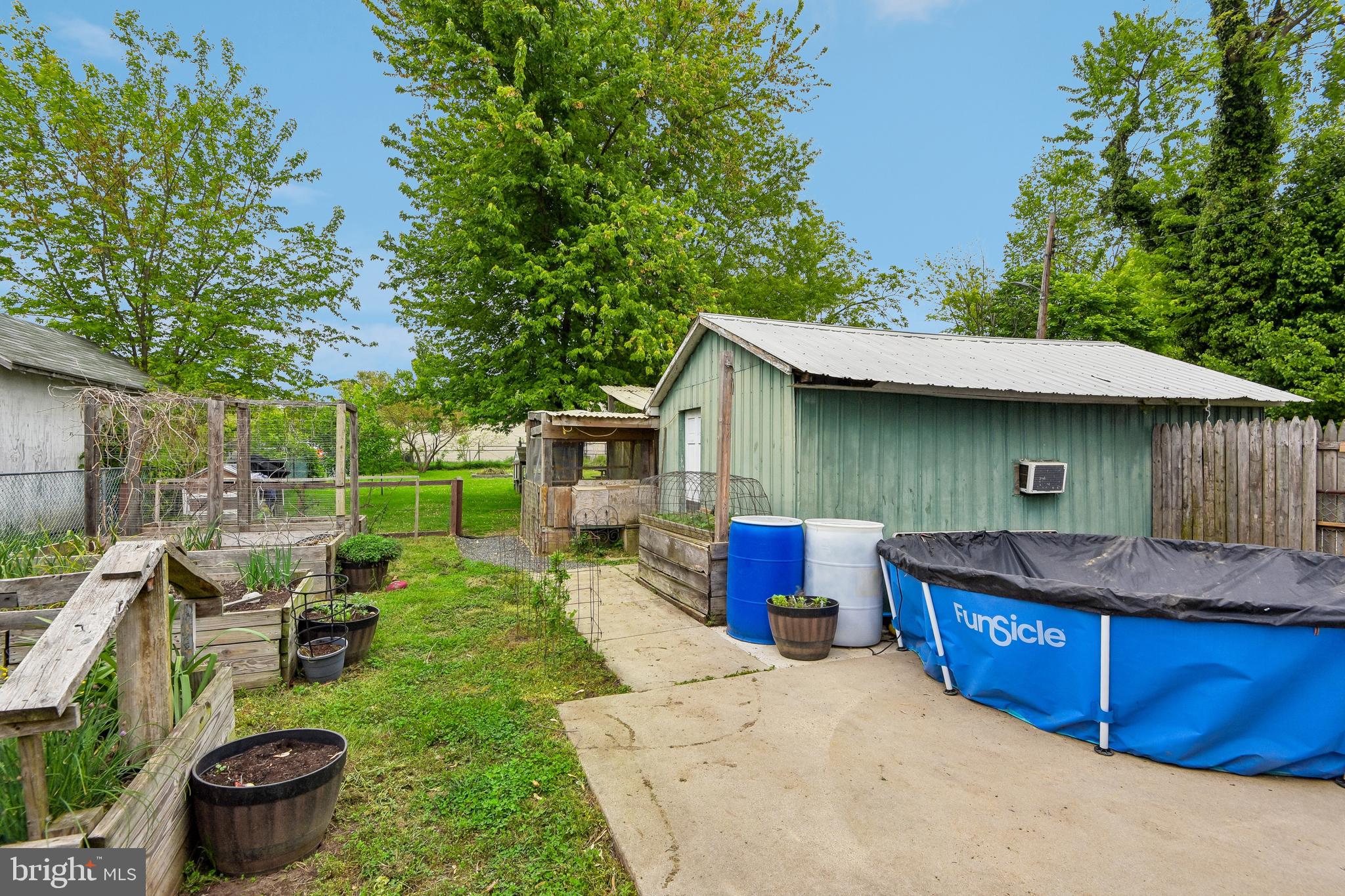 301 Custis Street Aberdeen, MD 21001 - Photo 23 of 29 a view of a backyard with table and chairs potted plants and a large tree