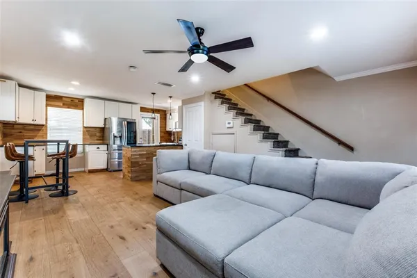 a living room with furniture and kitchen view