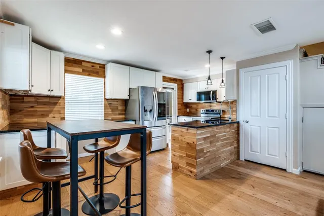 a kitchen with stainless steel appliances granite countertop a stove and a refrigerator