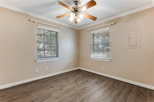 wooden floor in an empty room with a window