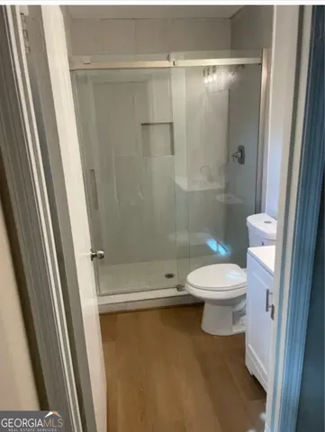 a bathroom with a toilet and a shower