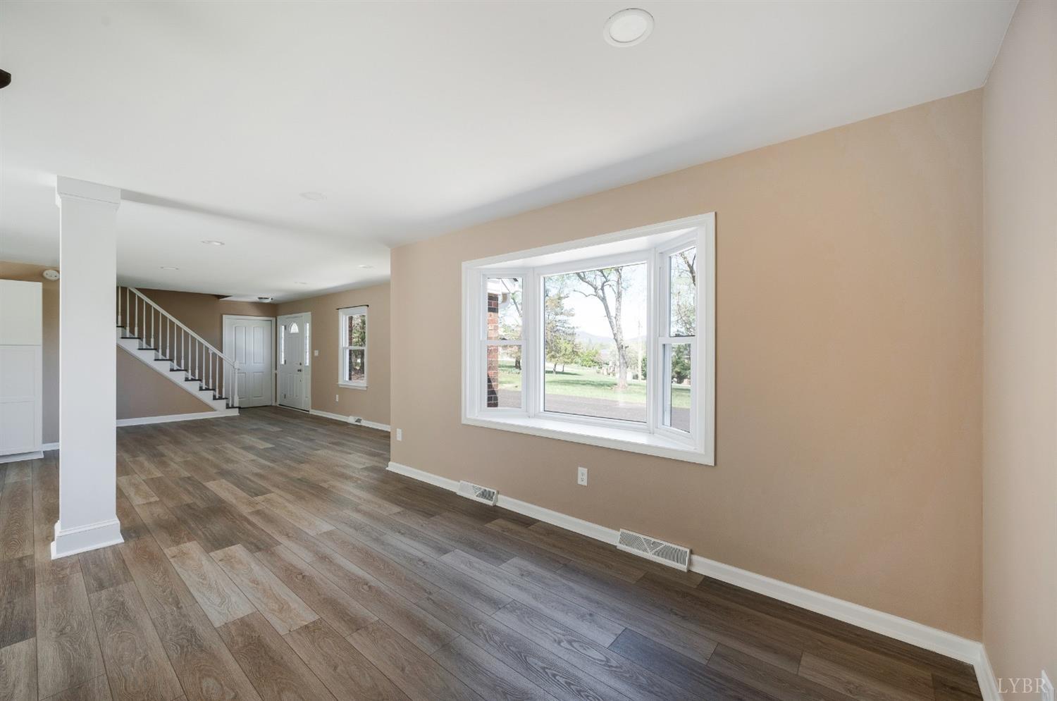 4070 Cottontown Road Forest, VA 24551 - Photo 13 of 38 an empty room with wooden floor and windows