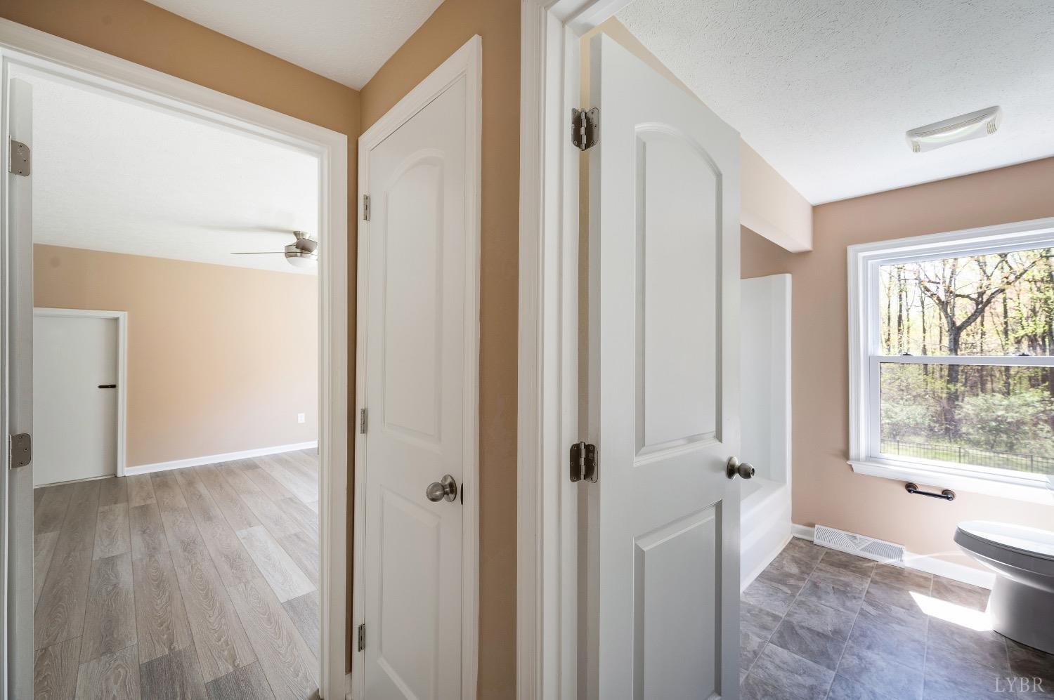 4070 Cottontown Road Forest, VA 24551 - Photo 23 of 38 a view of an empty room with wooden floor and a window