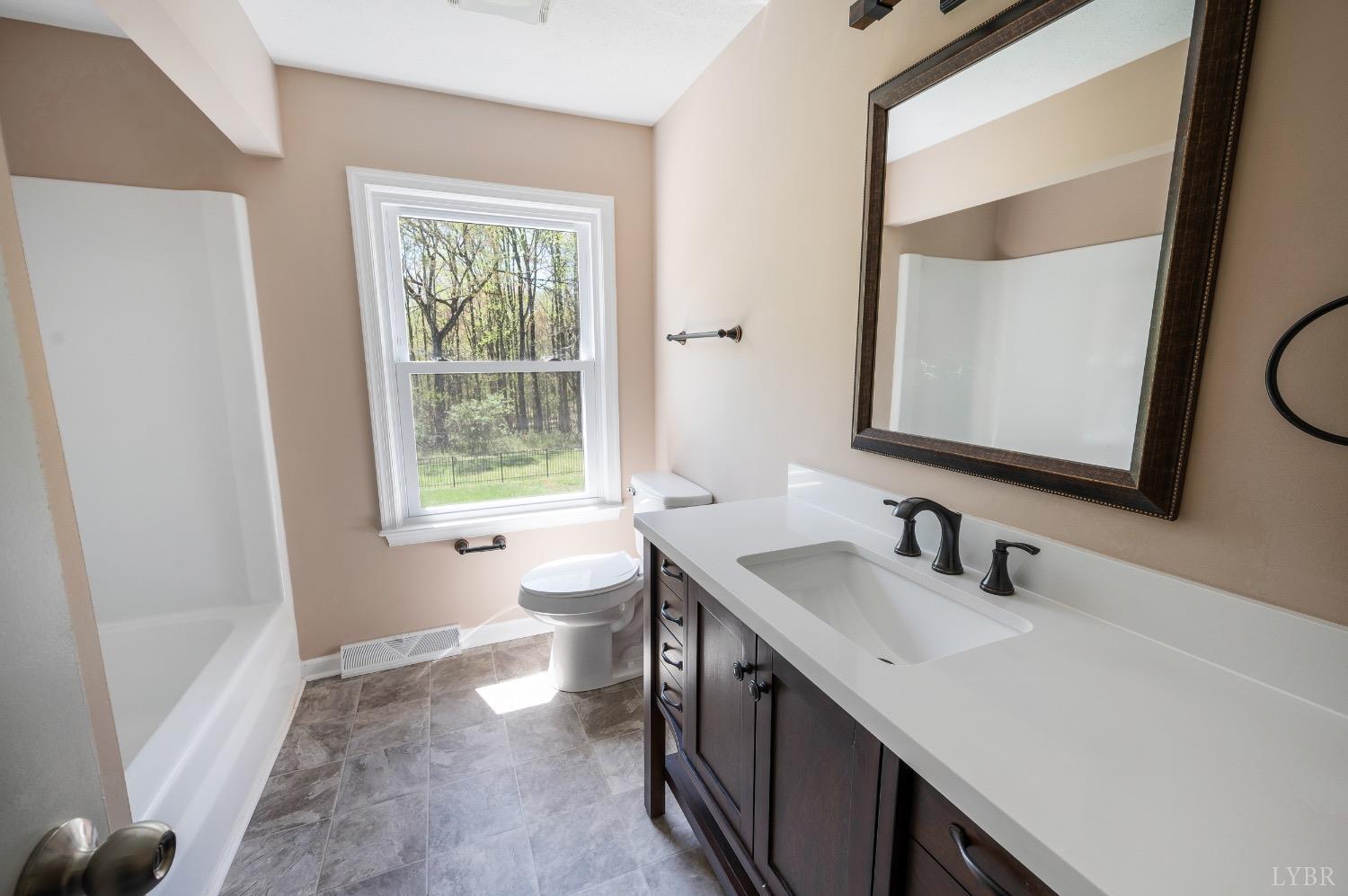 4070 Cottontown Road Forest, VA 24551 - Photo 24 of 38 a bathroom with a double vanity sink a mirror and a window