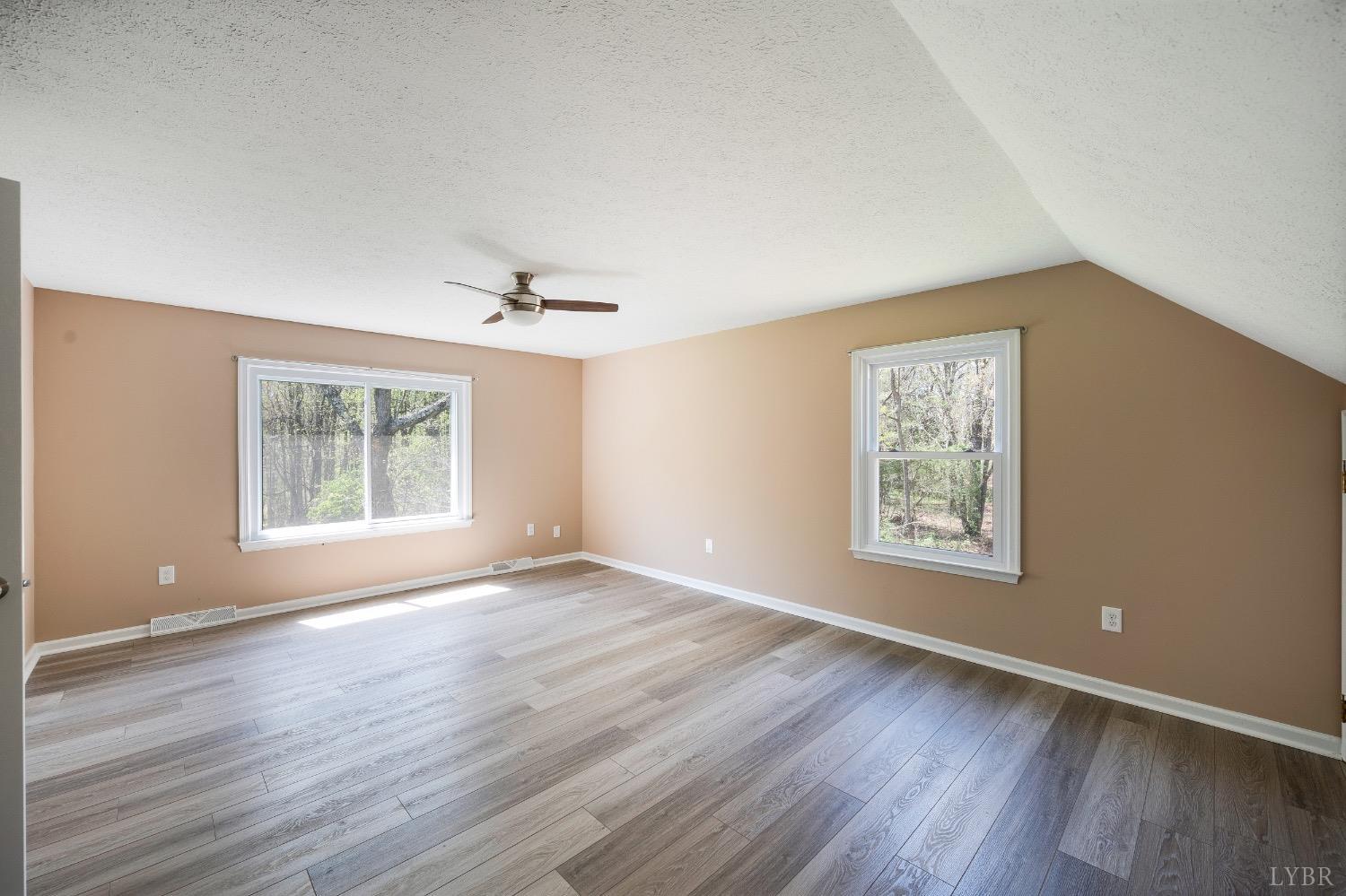 4070 Cottontown Road Forest, VA 24551 - Photo 27 of 38 a view of an empty room with wooden floor and a window
