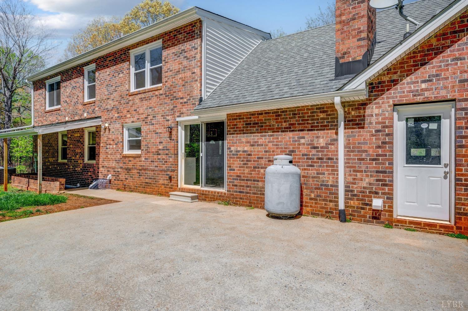 4070 Cottontown Road Forest, VA 24551 - Photo 32 of 38 a view of a brick house with many windows and plants