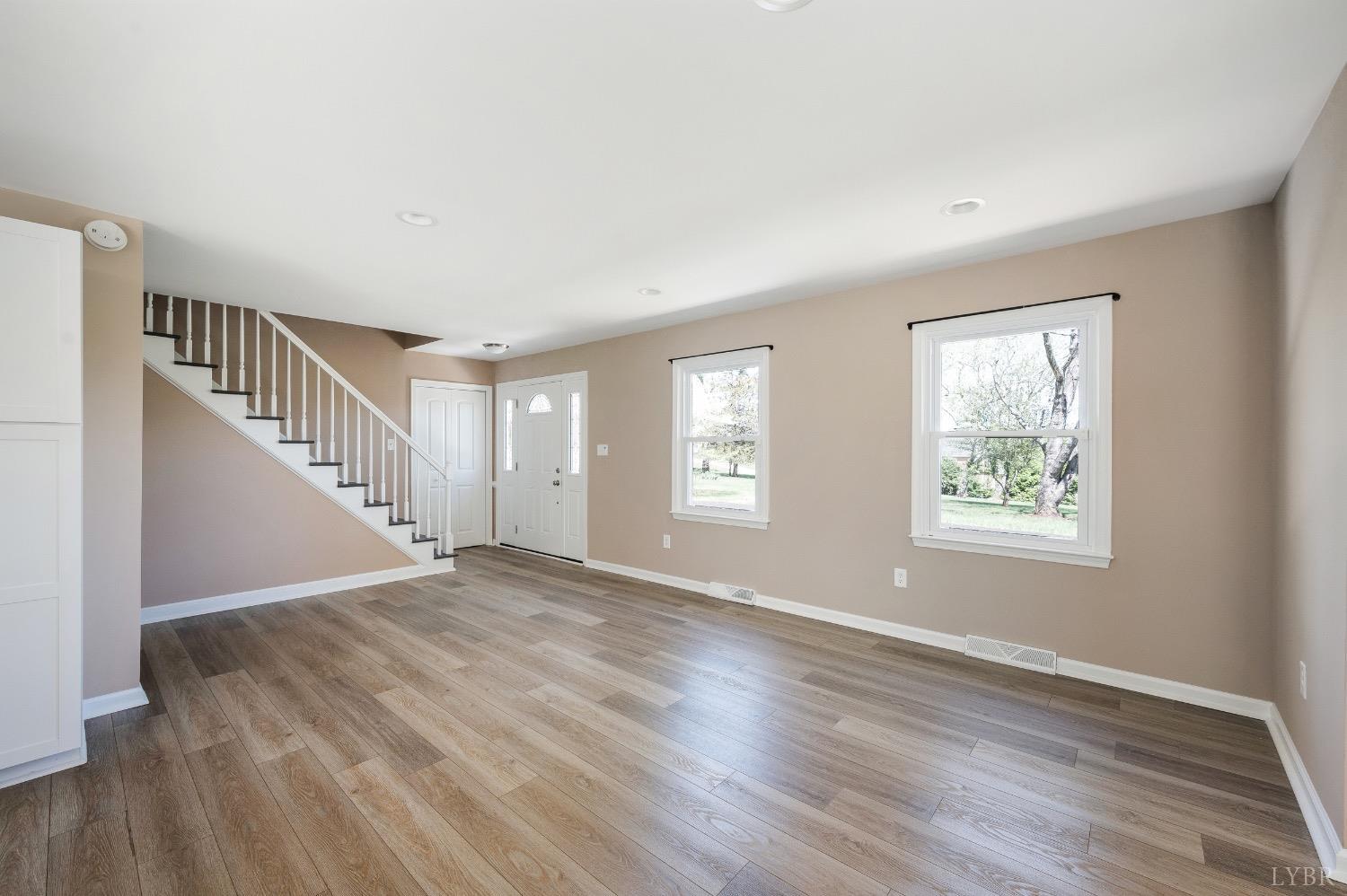 4070 Cottontown Road Forest, VA 24551 - Photo 4 of 38 a view of an empty room with wooden floor and a window