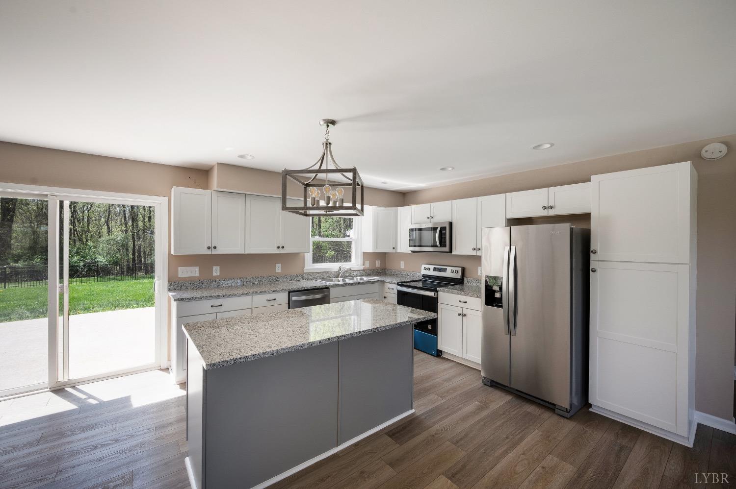 4070 Cottontown Road Forest, VA 24551 - Photo 5 of 38 a kitchen with a refrigerator a stove a sink and a hard wood floor