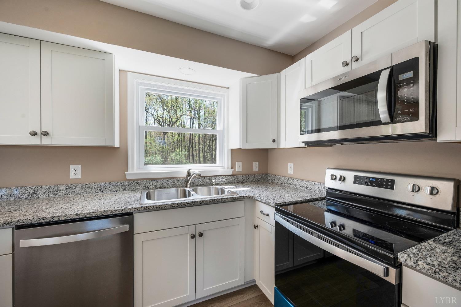 4070 Cottontown Road Forest, VA 24551 - Photo 6 of 38 a kitchen with stainless steel appliances cabinets and window
