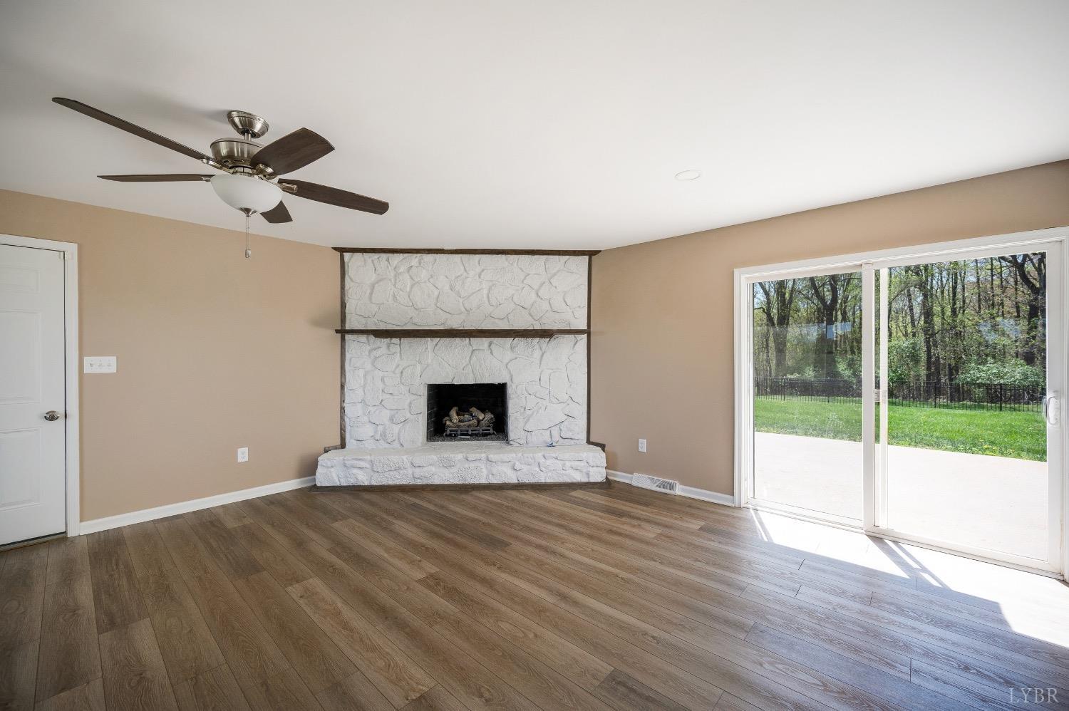 4070 Cottontown Road Forest, VA 24551 - Photo 10 of 38 a view of an empty room with a fireplace and a window
