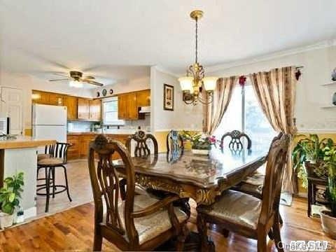386 Hawkins Road Centereach, NY 11720 - Photo 1 of 1 a dining room with furniture and window
