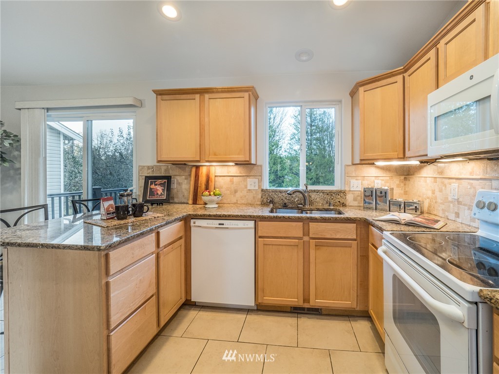 1307 196th Place Southeast Bothell, WA 98012 - Photo 6 of 25 a kitchen with a sink stove and cabinets