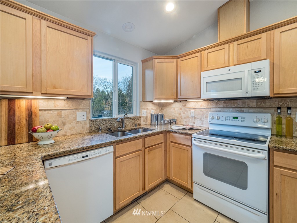 1307 196th Place Southeast Bothell, WA 98012 - Photo 7 of 25 a kitchen with a sink stove top oven and cabinets