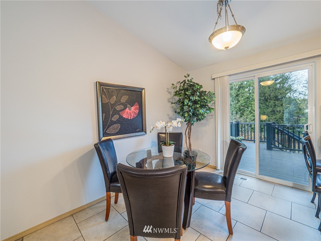 1307 196th Place Southeast Bothell, WA 98012 - Photo 8 of 25 a dining room with furniture a chandelier and window