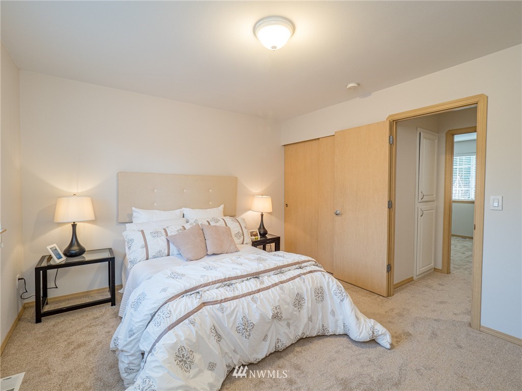 1307 196th Place Southeast Bothell, WA 98012 - Photo 9 of 25 a bedroom with a bed and a lamp