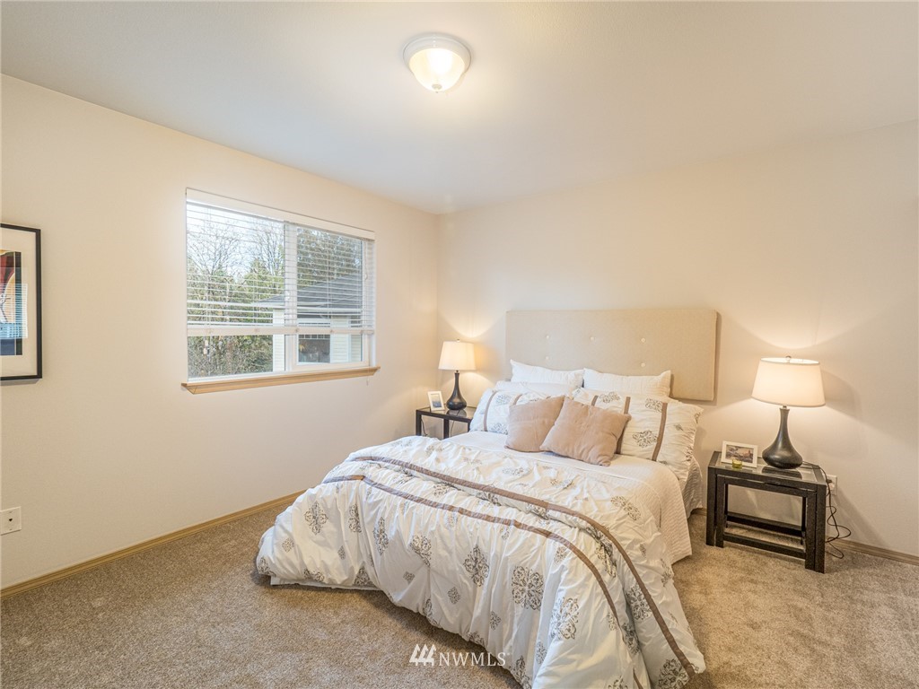 1307 196th Place Southeast Bothell, WA 98012 - Photo 10 of 25 a bedroom with a bed and a night stand