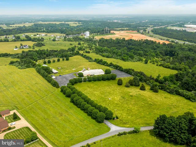a view of a house with pool and a yard