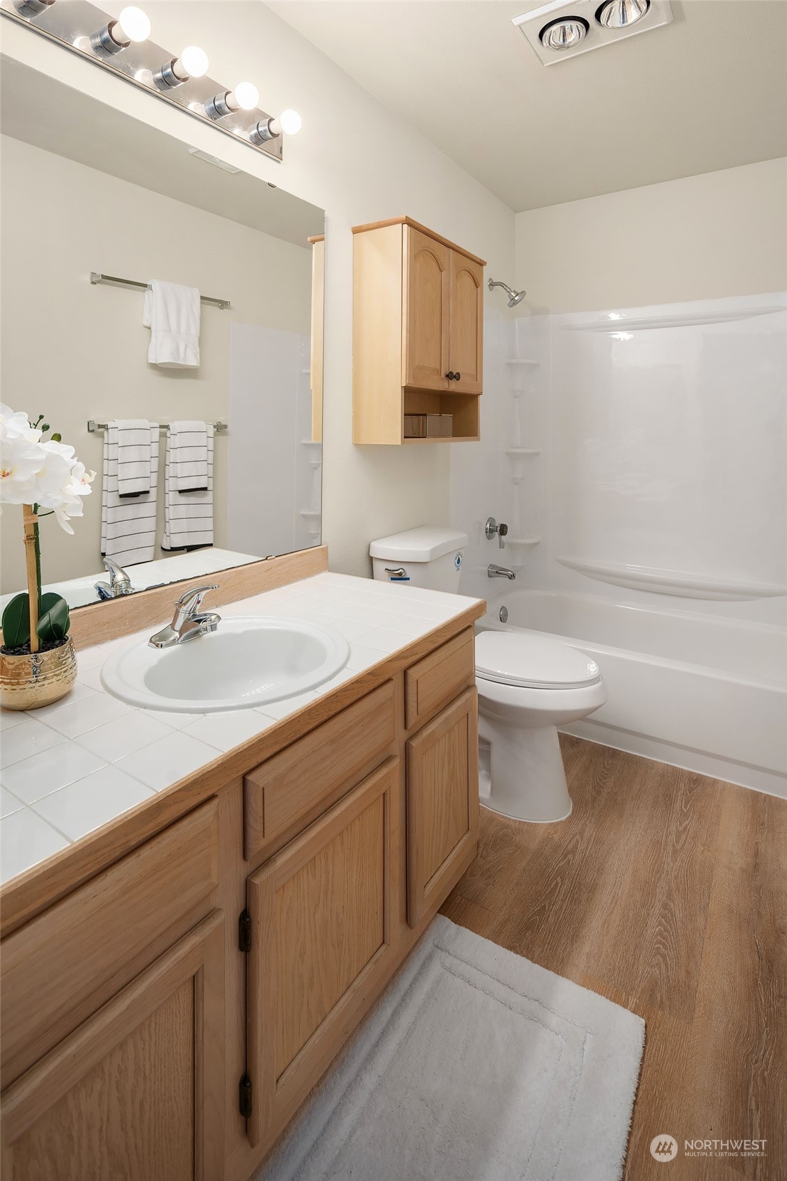 23111 15th Avenue Southeast, Unit E4 Bothell, WA 98021 - Photo 17 of 31 a bathroom with a sink a toilet and mirror