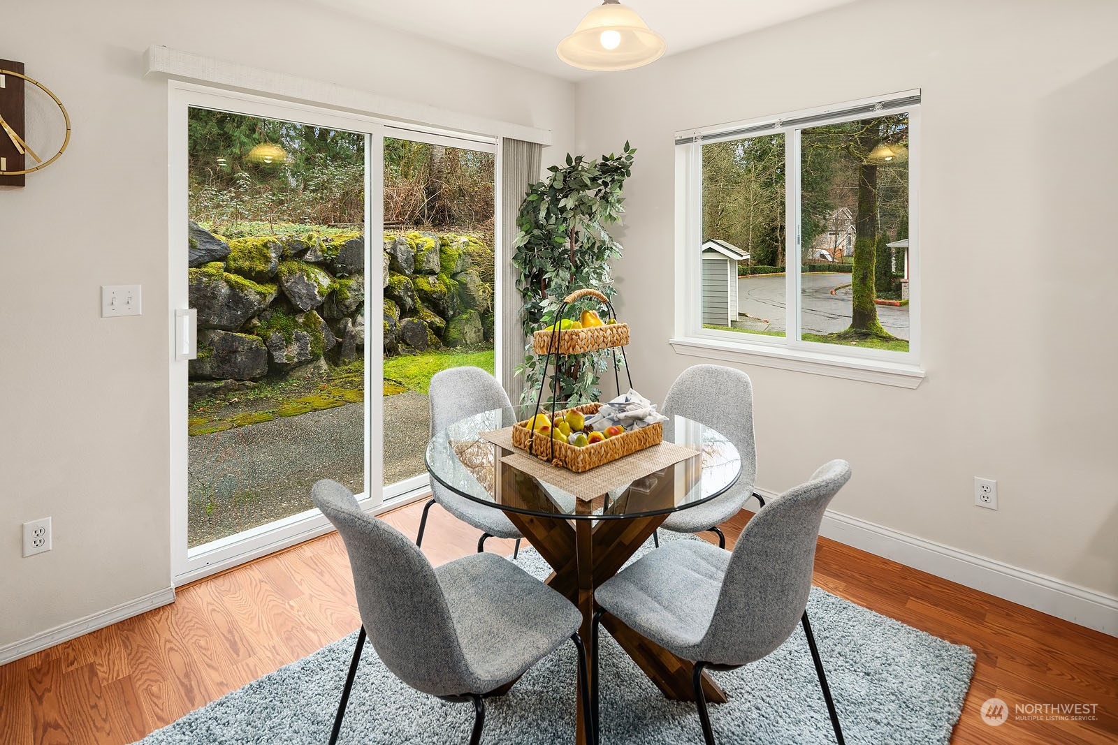23111 15th Avenue Southeast, Unit E4 Bothell, WA 98021 - Photo 9 of 31 a view of a dining room with furniture wooden floor and a potted plant