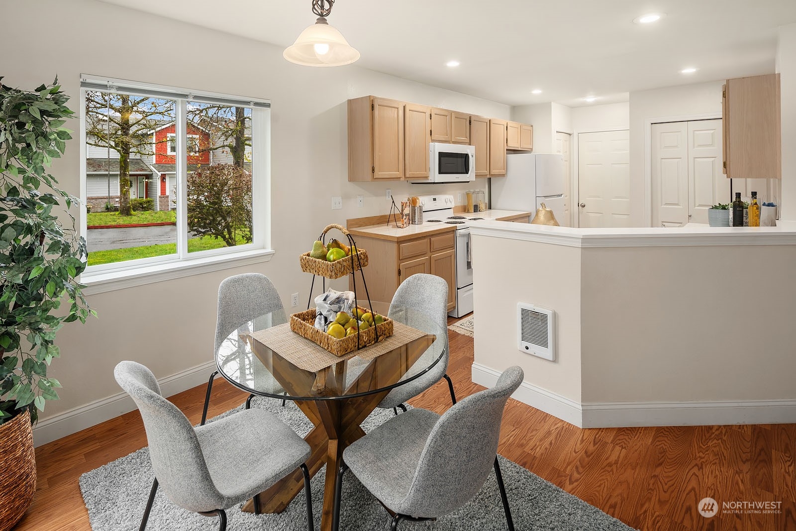 23111 15th Avenue Southeast, Unit E4 Bothell, WA 98021 - Photo 10 of 31 a kitchen with a dining table chairs and refrigerator