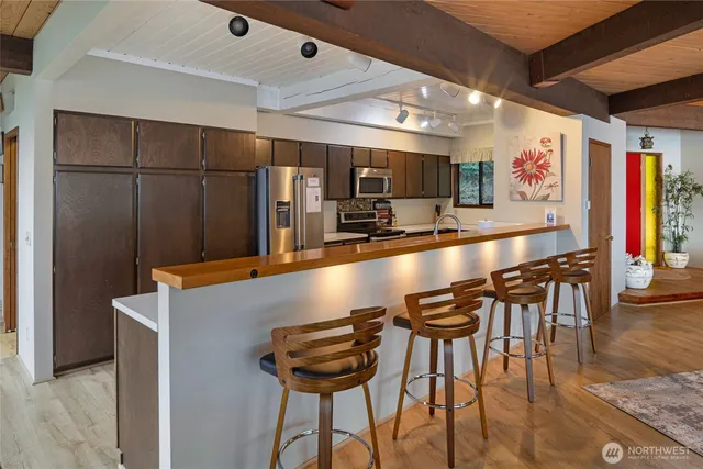 a view of a dining room with furniture wooden floor and chandelier