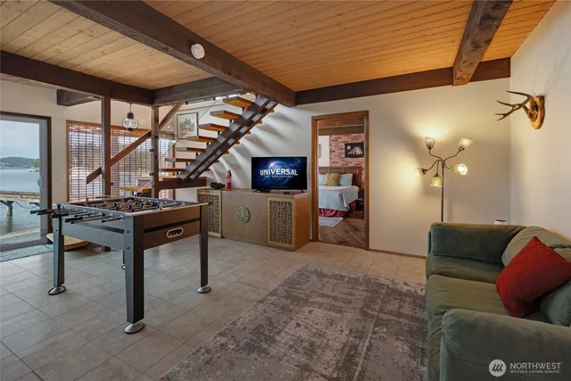 a spacious bedroom with a bed and wooden floor