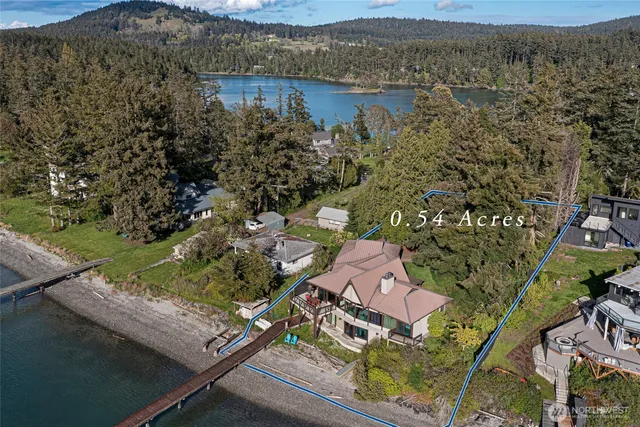 an aerial view of a house with a lake view