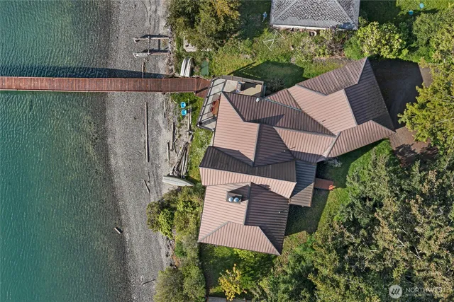 an aerial view of a house with garden space and street view