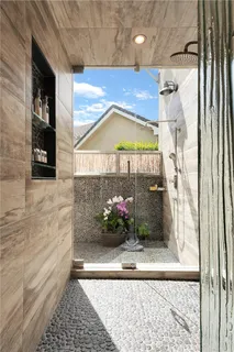 a view of a door and chair and potted plants