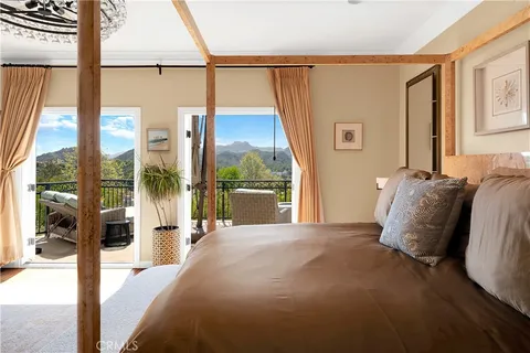 a bedroom with a bed a mirror table and chair