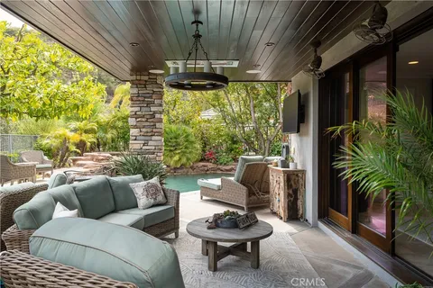 a balcony with outdoor seating and trees