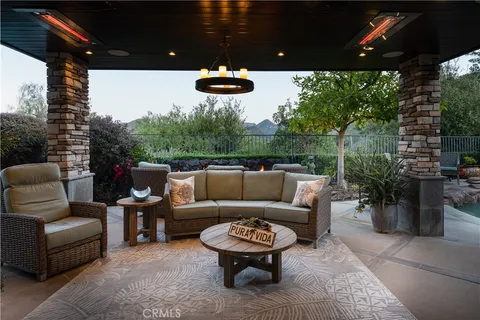 a patio with a table and chairs under an umbrella