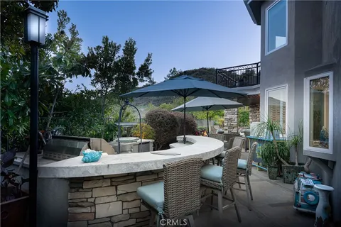 a view of a house with swimming pool and sitting area