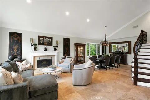 a living room with furniture a fireplace and a table