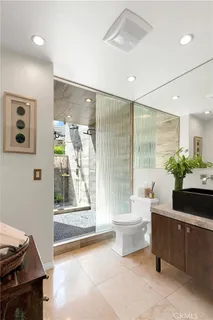 a spacious bathroom with a bathtub shower sink vanity and toilet