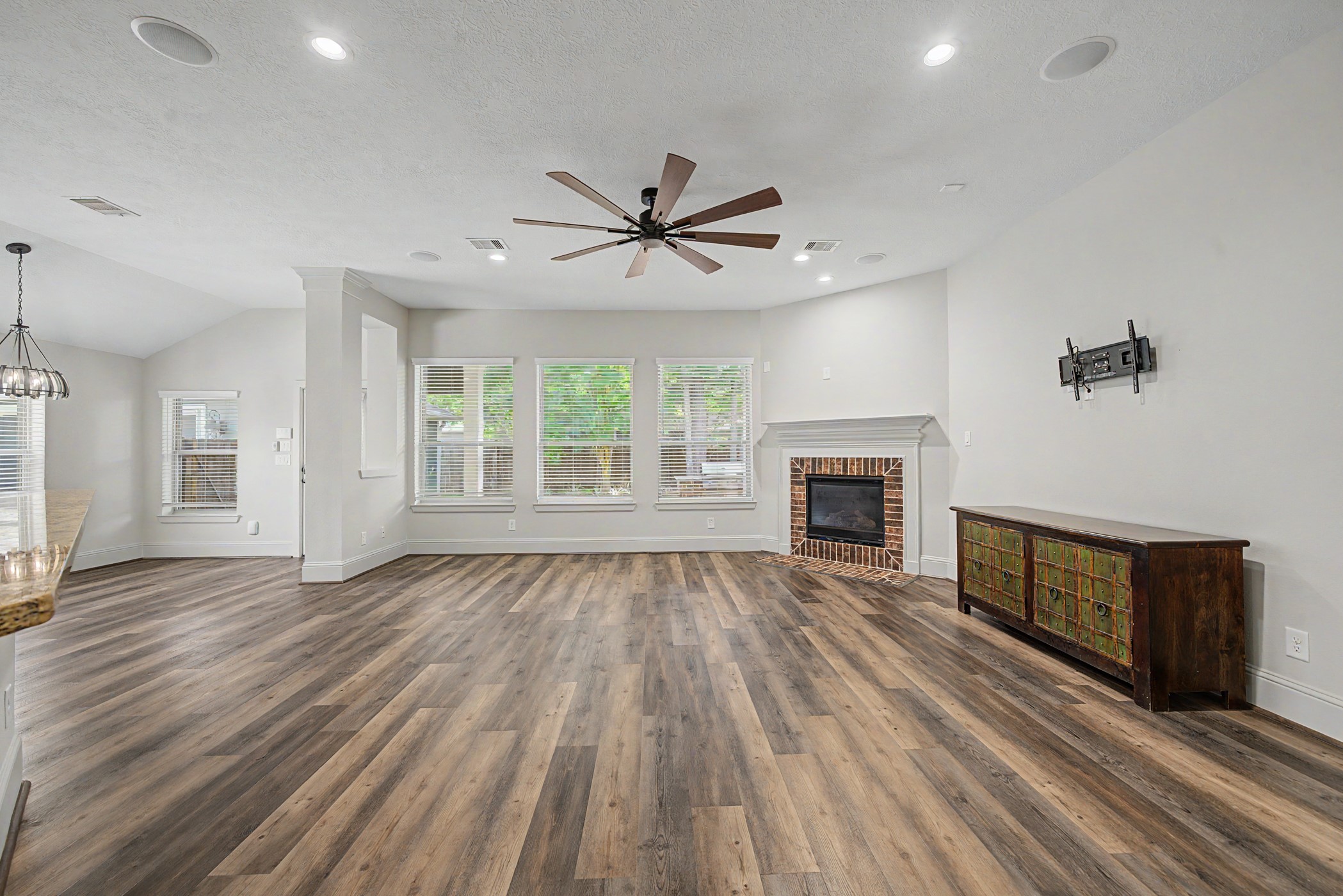 31032 Sunfall Trail Lane Spring, TX 77386 - Photo 11 of 39 wooden floor fireplace and natural light in a room