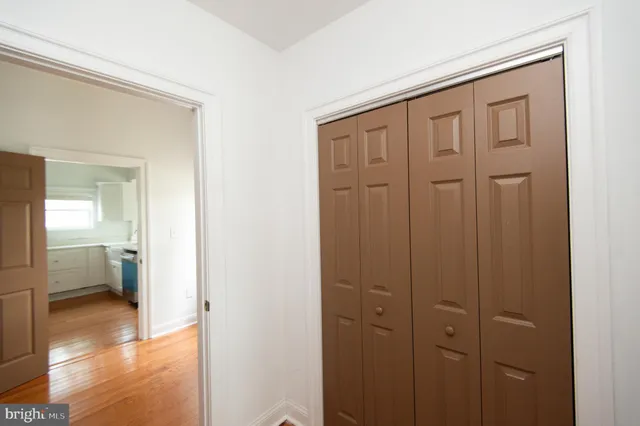 a view of a living room with furniture and wooden floor