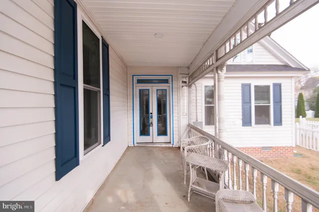 a view of a house with a yard and large tree