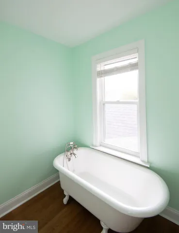 a view of a house with a yard and large tree