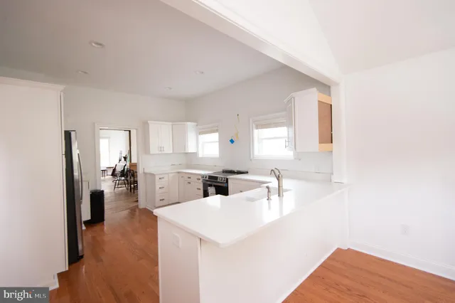 a kitchen with stainless steel appliances a refrigerator and cabinets